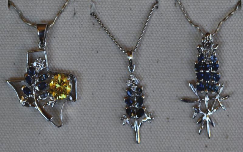 Custom-made Texas and bluebonnet pendants are crafted and sold at Bluestar Jewelers. MADELEINE MILLER | DISPATCH RECORD