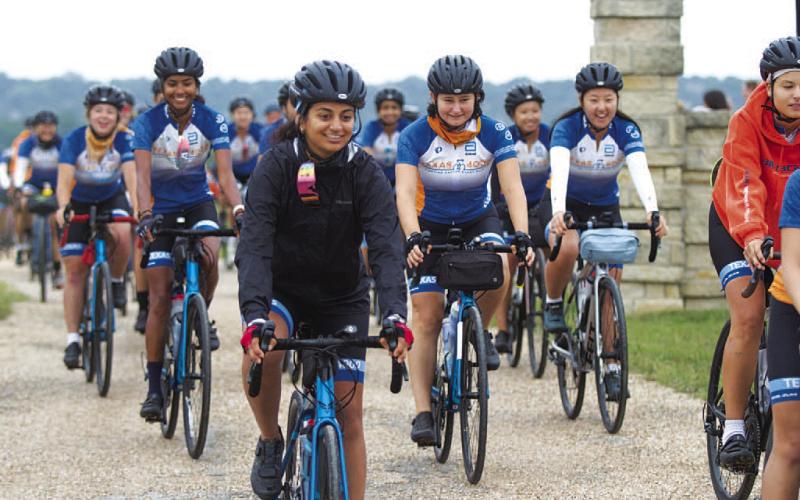 HUNTER KING | DISPATCH RECORD University of Texas students ride out with a smile on their face to start the trip to Alaska.