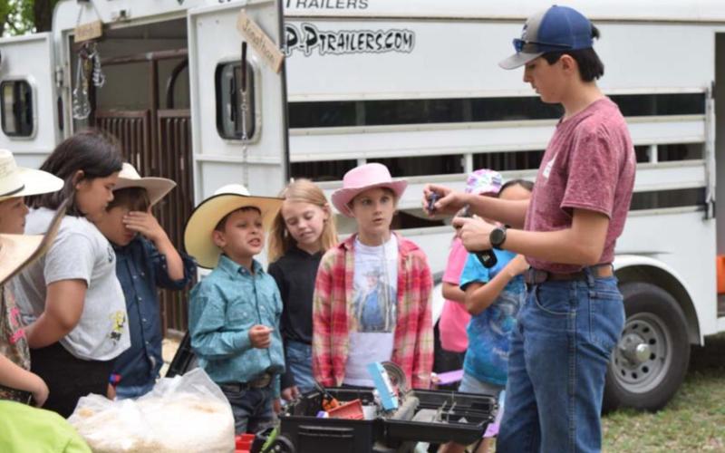 Lampasas County 4-H and FFA student Jonathan Harris demonstrates for Morgan Mann’s second-grade class the type of razor used to groom sheep. ALEXANDRIA RANDOLPH | DISPATCH RECORD