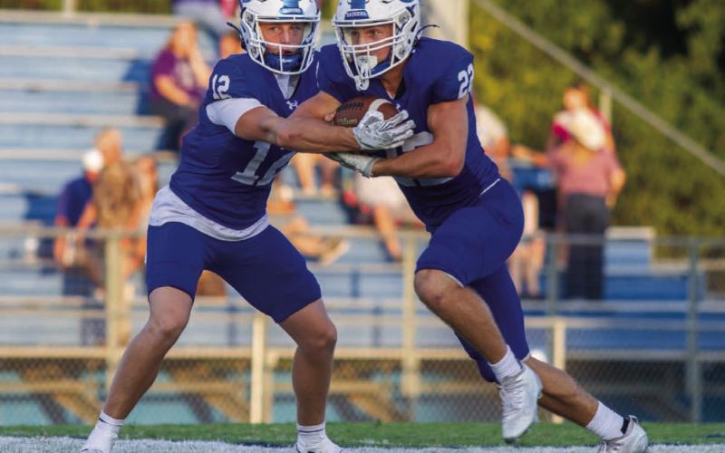 Sophomore quarterback Ross Kothmann makes the handoff to running back John Stenson in the Badgers’ Week 2 non-district game versus Pflugerville Connally. The Badgers went into overtime for the first time since 2018 and ultimately lost on the Cougars’ successful extra point. ANA SOFIA MEYER| DISPATCH RECORD