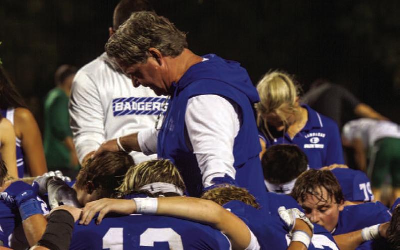 Lampasas head football coach Troy Rogers leads a team prayer after the Badgers’ heartbreaking loss against Pflugerville Connally. ANA SOFIA MEYER | DISPATCH RECORD