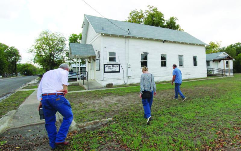 Samantha Hunick, representing Preservation Texas, is accompanied by Boyce Cabiness (left) and Eddie Bowden as they walk towards New Hope Baptist Church. The church is just one of the four landmarks the newly formed Lampasas Cornerstone Conservancy hopes to preserve. JOYCESARAH MCCABE | DISPATCH RECORD