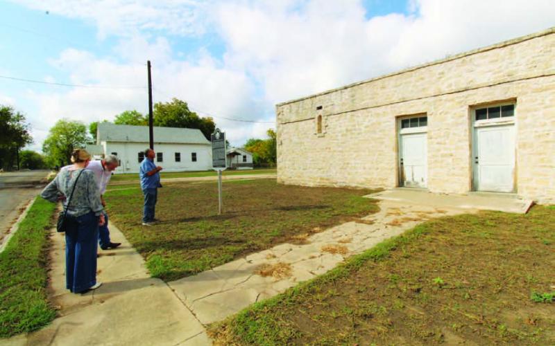 JOYCESARAH MCCABE | DISPATCH RECORD Eddie Bowden, Boyce Cabiness (center) and Samantha Hunick, from Preservation Texas, survey and discuss the condition of the Colored School. The school sits beside New Hope Baptist Church and in front of the remains of the Moses Hughes Mill on Sulphur Creek.
