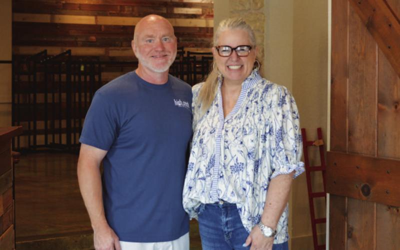 COURTESY PHOTO Merk &amp;amp; Tilley’s owners Jo and John Williams pause for a photo between customer checkouts on their second-to-last day in business on Friday morning.