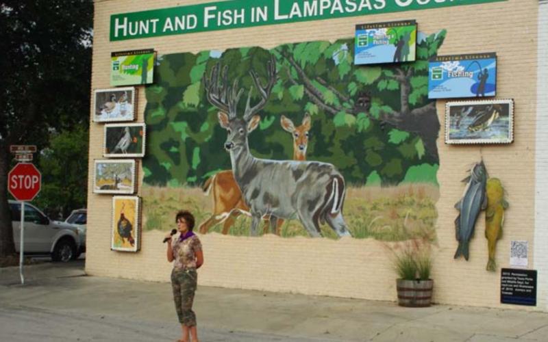 Vision Lampasas member Libby Bluntzer speaks at the 2012 unveiling of the organization’s “Hunt and Fish in Lampasas County” mural. BILL MCDONALD | COURTESY PHOTO