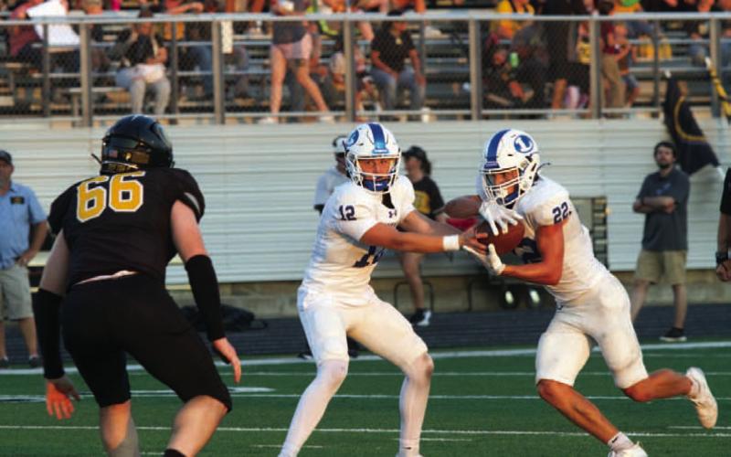 Ross Kothmann makes a handoff to John Stenson against Gatesville. ANA SOFIA MEYER | DISPATCH RECORD