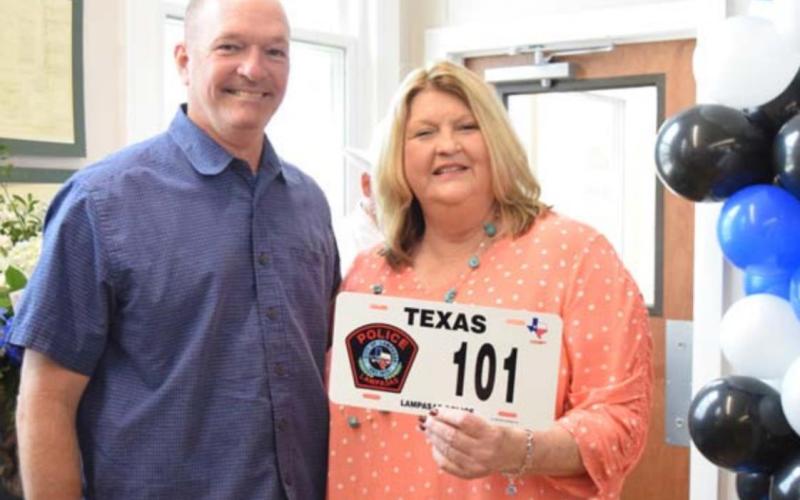 Texas DPS Patrol Sgt. Ryan McKittrick presents Sammy Bailey with a novelty Highway Patrol plate in honor of her retirement. ALEXANDRIA RANDOLPH | DISPATCH RECORD