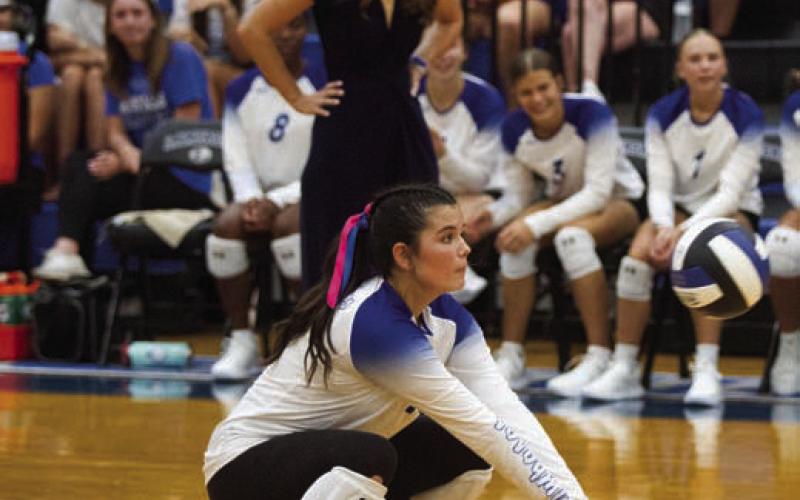 McKinnley Farmer crouches for a dig in the third set of Tuesday’s win over Manor New Tech. ERICK MITCHELL | DISPATCH RECORD