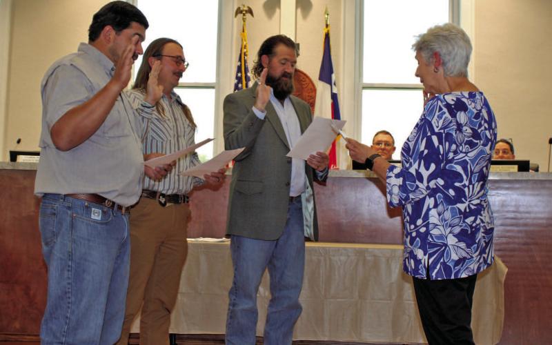 Outgoing Mayor TJ Monroe administers the oath of office to newly elected Lampasas City Council members, from left, Eric Hernandez, Zachary Morris and Charles Pratus. Hernandez and Pratus are serving their first terms, while Morris was re-elected May 6 for a new term on the council. COURTESY PHOTO