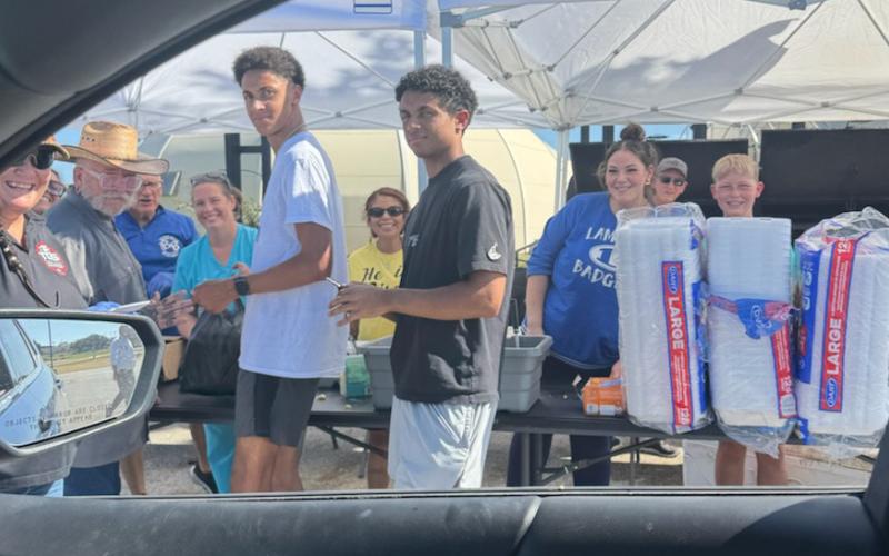 Volunteers were on hand Aug. 13 outside Grace Fellowship for a drive-through pork chop dinner fundraiser to benefit Building Badgers Youth League. Benny Boyd provided all the food so proceeds could be used for the BBYL young Badgers athletic programs. COURTESY PHOTO