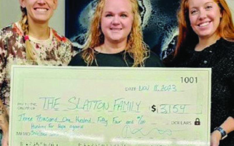 COURTESY PHOTO Folded Owl founder Lacey Schwab, at right, stands alongside Amber Slatton, who received donations from the Hunting4Hope event last year to help her son Cole battle cancer.