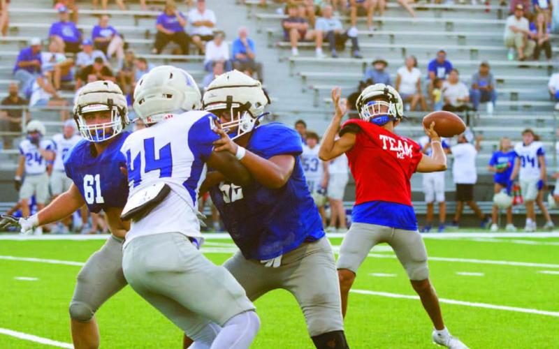 At right, Tripp Stinnett prepares to throw the ball down field during Lampasas High’s scrimmage against the McCallum Knights on Thursday in downtown Austin. ERICK MITCHELL | DISPATCH RECORD