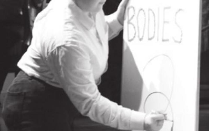 Annabella Jorstad writes “2” on a white board titled “Dead Bodies,” which was changed each time a body was found by the characters in the play. CHRIS YBARRA | DISPATCH RECORD
