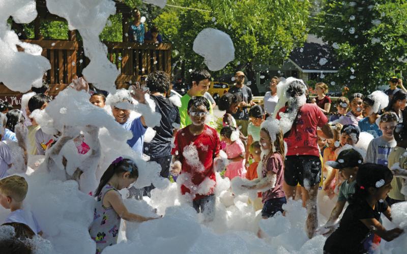 Children partied under a blanket of foam during the Lampasas Public Library’s Summer Reading program launch party on Friday. ERICK MITCHELL | DISPATCH RECORD