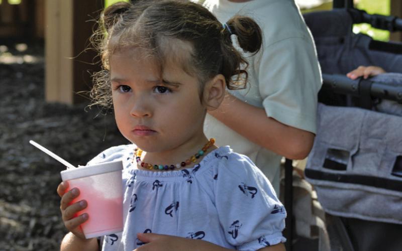 ERICK MITCHELL | DISPATCH RECORD Maria Valeria White and Rodrigo Manuel White enjoy their snowcones during Friday’s festivities at the Lampasas Public Library.
