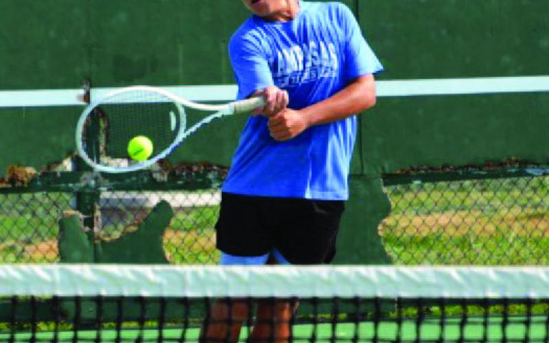 Dylan Skarzynski levels a volley back to his opponent in Tuesday’s singles match versus Weiss. COURTESY PHOTO