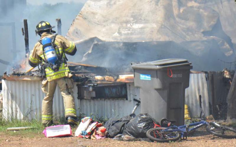 In this August 2022 file photo, a Lampasas firefighter extingushes a fire at a mobile home. Lampasas Fire Chief Jeff Smith encourages every household to have an emergency plan. FILE PHOTO