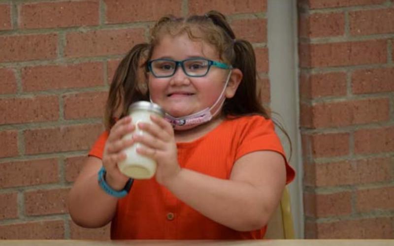 Six-year-old Avery Kowalske works on her mixture of milk and lemon juice in what was a fun way to learn about emulsion. ALEXANDRIA RANDOLPH | DISPATCH RECORD