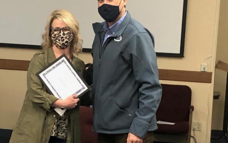 Superintendent Dr. Chane Rascoe presents a certificate of appreciation to Donna Clark, the director of school health services, for her work this year. COURTESY PHOTO