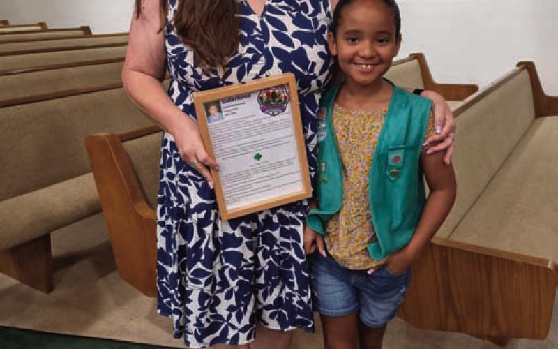 Sara Cook and Riley Cook accept the memorial Sisterhood Patch, a local patch named to recognize the late Yvonne Cook. COURTESY PHOTO