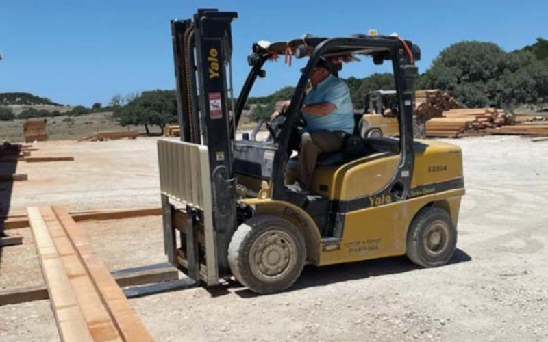 Herb Pearce loads lumber at his BHR Timber facility. He is one of a group of local builders who will provide mentorship this fall for students in a construction science course at the high school. MASON HINES | DISPATCH RECORD