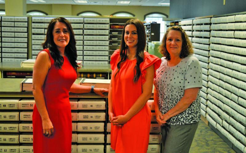 Lampasas County Clerk Dianne Miller and her staff members Dallas Munoz and Dawn Rodman, left to right, stand in a storage room that contains hard copies of county land records. On June 10, these books of property records such as deeds, judgments and tax liens will be taken to a Dallas imaging facility to be digitized. ERICK MITCHELL | DISPATCH REACORD