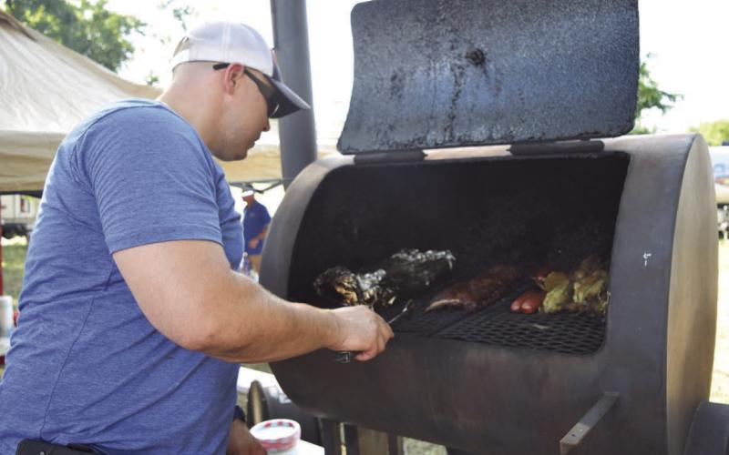 An LTX BBQ Fest cook-off contestant loads his smoker full of meats at a previous edition of the event. As that event has faded, Michael Olson, a former organizer of the LTX BBQ Fest and Creating Badger Builders member, has launched a new competition. The “Hotter than Hell 2.0” Barbecue Cookoff hosted by the local nonprofit plans to raise money for trade school scholarships through the contest. FILE PHOTO