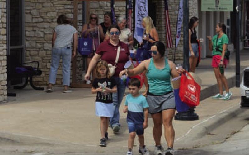 Sip ’N’ Shop customers enjoyed strolling the downtown square during Tuesday’s event. ERICK MITCHELL | DISPATCH RECORD