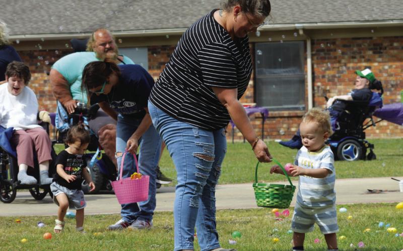 Toddlers required a little bit of help fiilling up egg baskets during Friday’s hunt. ERICK MITCHELL | DISPATCH RECORD