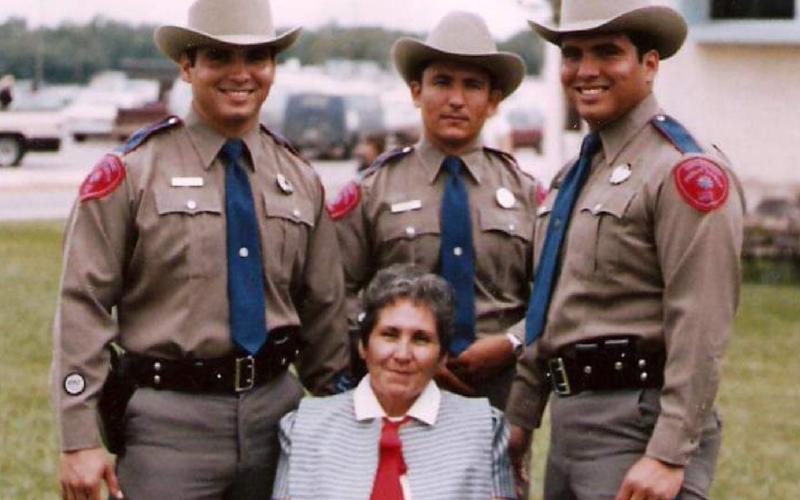 Brothers Jose “Joe” Ramos, at left, Juan “John” Ramos, back center, and Jesus “Jess” Ramos pose for a photo in Texas DPS uniform with their mother, Maria Luisa Ramos. courtesy photo