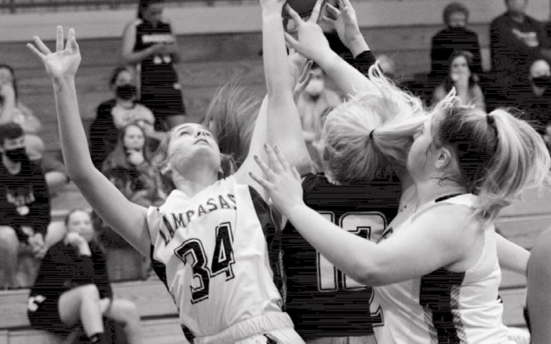 Freshman Jamie Ball (34) and sophomore Morgan Lovejoy go for a rebound. JEFF LOWE | DISPATCH RECORD