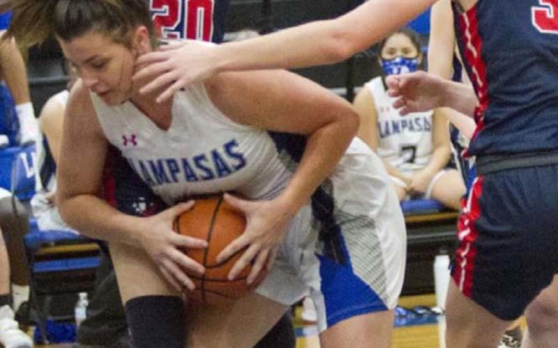 Rebekah Pearce protects the ball against a tight defense in the lane. JEFF LOWE | DISPATCH RECORD