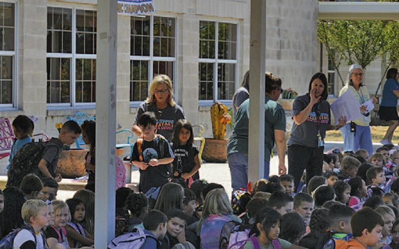 Students at Hanna Springs Elementary School await their rides home after the first day of classes. On the first day of the new term, the campus showed an enrollment of 714. Those numbers were expected to increase slightly over the early part of the 2023-24 school year. ERICK MITCHELL | DISPATCH RECORD