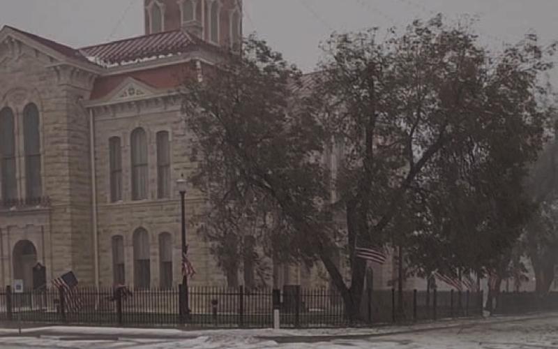 The downtown courthouse square appears to be blanketed in snow after a hail storm Friday. The hail pummeled trees, buildings and vehicles, and left broken limbs and leaves plastered across yards and sidewalks. TERESA THORNTON | DISPATCH RECORD