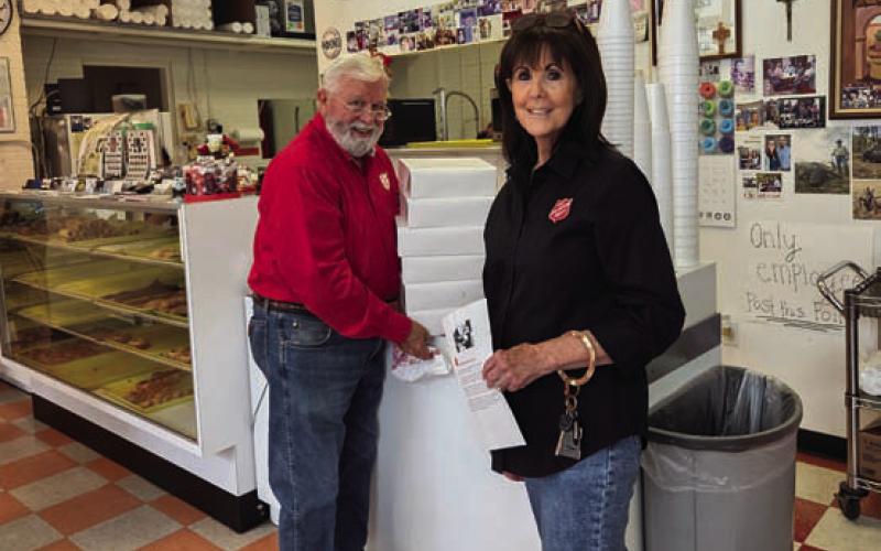 Salvation Army board members David Spradley and Sherry Gillen Milligan pick up doughnuts from Donut Palace for the distribution committee to bring to various law enforcement and first responder agencies in the county. COURTESY PHOTO