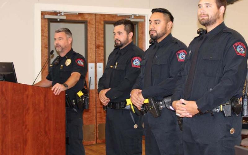 Patrol Lt. Chuck Montgomery presents new police officers Brandon English, John Reza and Jameson Varnado, left to right, at a Lampasas City Council meeting on Monday. COURTESY PHOTO