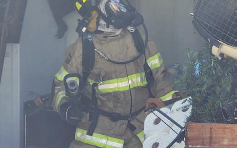 A Kempner firefighter examines the ceiling during fire suppression activities Sunday afternoon. COURTESY PHOTO