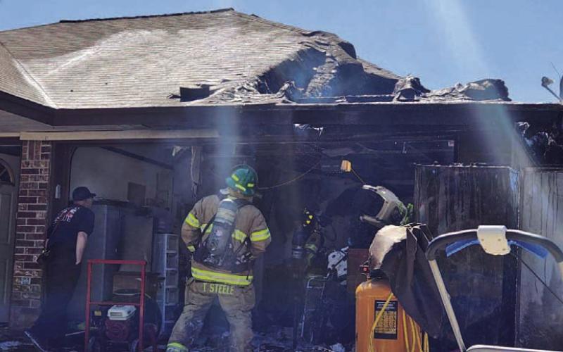 Firefighters work to put out a house fire in the 600 block of County Road 3365 on Sunday. COURTESY PHOTO