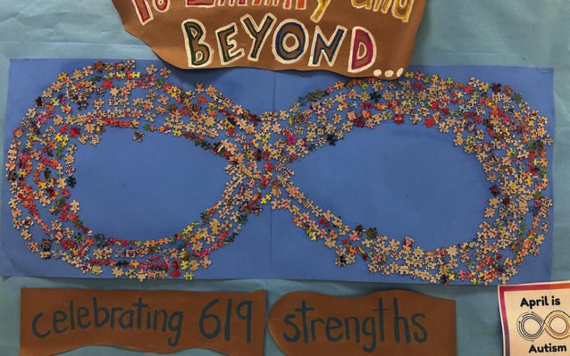 All 619 Taylor Creek Elementary School students played a part in this infinity symbol that recognizes April as Autism Awareness month. COURTESY PHOTO