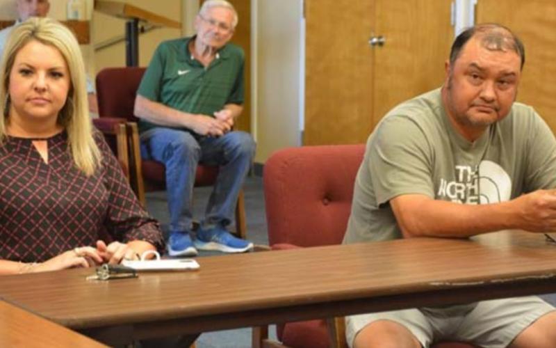 School board candidates Kelsi Davis and Harvey Stinnett listen to school officials explain their choice of action after the May 7 election results ended in a tie. MONIQUE BRAND | DISPATCH RECORD