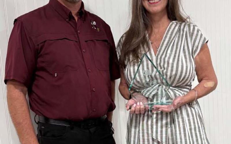 COURTESY PHOTO Superintendent Rob Moore congratulates UIL Sponsor Excellence Award recipient Cheri Jay-Wienecke. She has served as a UIL speech and debate coach for the Lometa ISD for many years, helping her students win numerous state championships and garner countless awards at the district and regional level.
