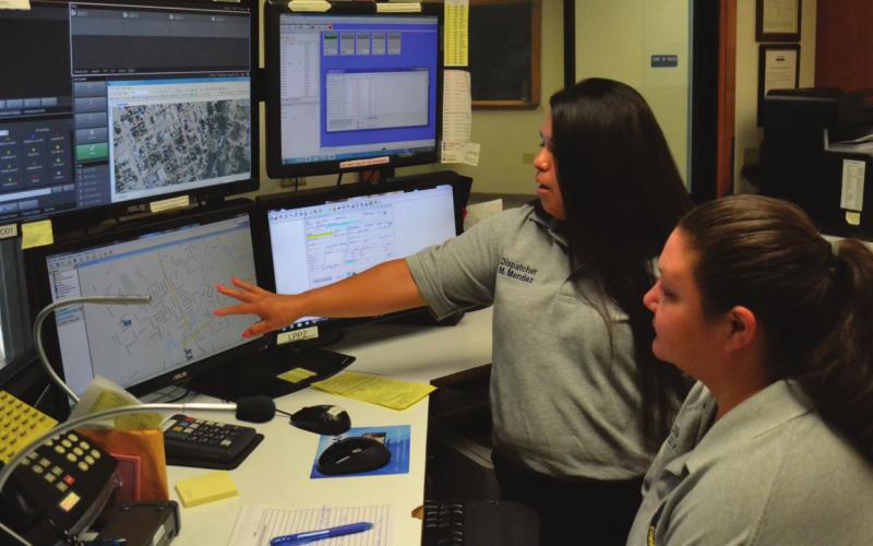 Lampasas Police Department communications personnel Mary Mendez, left, and Danicka Keeling look over maps and data relating to 911 calls. Some of the equipment pictured will be replaced as the police department updates its communications equipment. FILE PHOTO