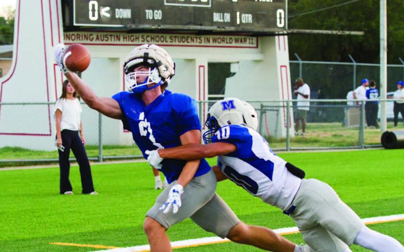 Brayden McLoughlin reaches for a one-handed snag in a scrimmage versus McCallum High on Aug. 20 in Austin. ERICK MITCHELL | DISPATCH RECORD