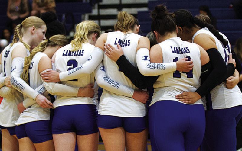FILE PHOTO The Lady Badger volleyball players huddle up before a game on the road this past season.