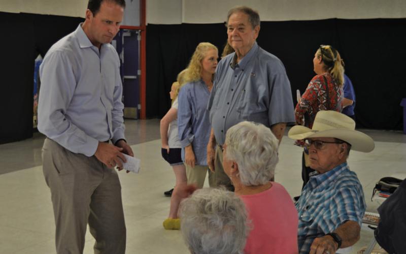 Congressman August Pfluger, at left, visits with constituents Tuesday before the start of his town hall gathering in Lampasas. A member of the Air Force Reserves, Pfluger spent time this summer in the Middle East and offered his thoughts about the status of the U.S. military. ERICK MITCHELL | DISPATCH RECORD