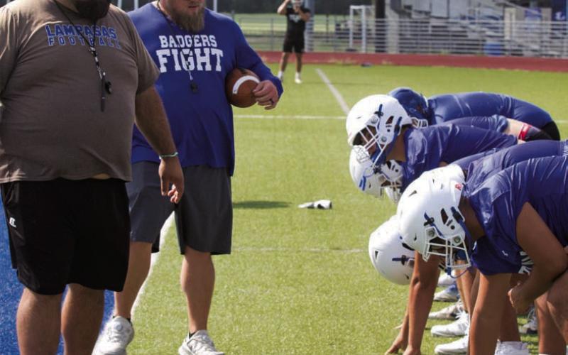 Assistant coaches TJ Cleavinger, left, and Donovan Kleckner oversee a special teams drill on Tuesday. ERICK MITCHELL | DISPATCH RECORD