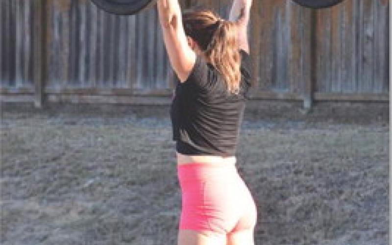 A middle-aged woman lifts weights during a functional fitness competition in Houston. Competition is an enjoyable aspect of fitness that can encourage commitment to exercise. alexandria Randolph | dispatch record