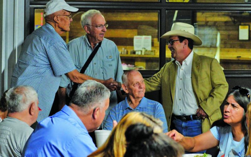 ERICK MITCHELL | DISPATCH RECORD State Senator Pete Flores (R-Pleasanton), at right, visits with Lampasas County residents before speaking at Thursday’s local Republican Party gathering.