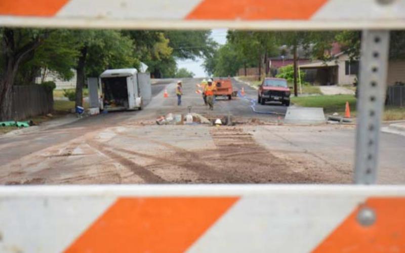 Lampasas public works employees work on a city street Tuesday. MONIQUE BRAND | DISPATCH RECORD