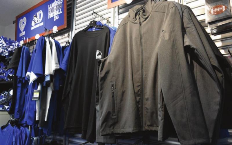 Logos of one’s choice can be added to apparel on display at Badger Tracks Customs. MADELEINE MILLER | DISPATCH RECORD